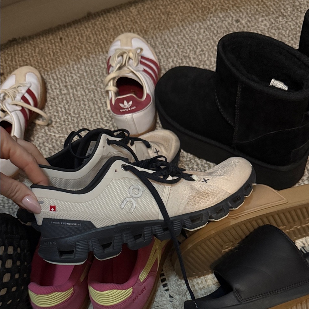 On Running Cream and Black Sneakers